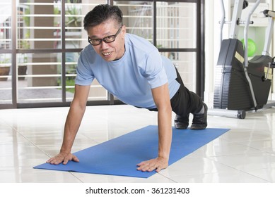 Asian Senior Male Streching At The Gym