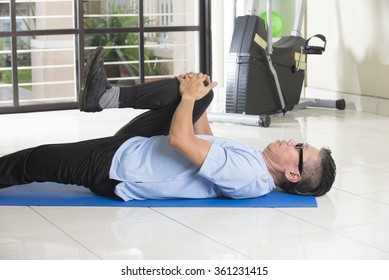 Asian Senior Male Streching At The Gym