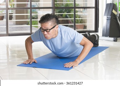 Asian Senior Male Streching At The Gym