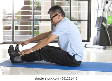 Asian Senior Male Streching At The Gym