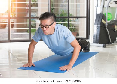 Asian Senior Male Streching At The Gym

