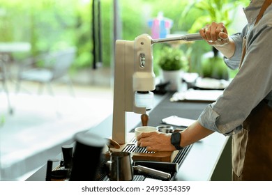 Asian senior man barista wearing apron preparing coffee in a modern coffee shop. - Powered by Shutterstock