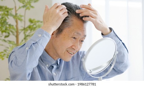 Asian Senior Man Checking Hair