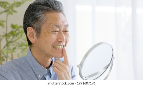 Asian Senior Man Checking Teeth