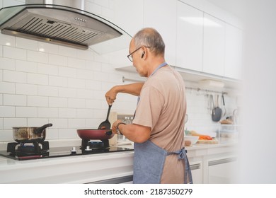 Asian Senior Man Cooking In Kitchen, Healthy Food