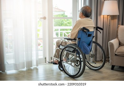 Asian senior man disabled sitting alone sitting in wheelchair looking through window at hospital, lonely elder thoughtful sad old man look outside windows in bedroom at retirement home, feel depressed - Shutterstock ID 2209310319
