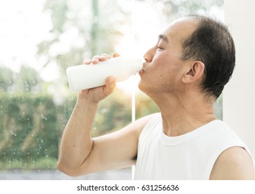 Asian Senior Man Drinking Milk.