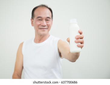 Asian Senior Man Drinking Milk Isolated On White Background.