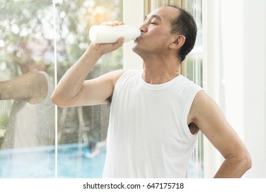 Asian Senior Man Drinking Milk.