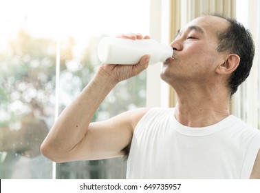 Asian Senior Man Drinking Milk.