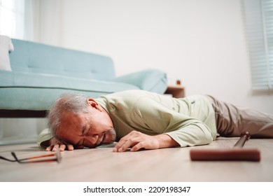 Asian Senior Man Falling On The Ground With Walker In Living Room At Home. Elderly Older Mature Male Having An Accident Heart Attack For Emergency Help Support From Hospital. Insurance Health Care.