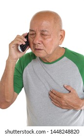 Asian Senior Man Getting Chest Pain While Talking On Cordless Phone