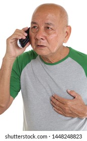 Asian Senior Man Getting Chest Pain While Talking On Cordless Phone