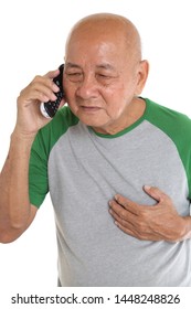 Asian Senior Man Getting Chest Pain While Talking On Cordless Phone