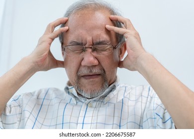 Asian Senior Man Having Headache. Stressed And Depressed From Health Problem Or Financial Crisis. Brain Painful From Alzheimer's Disease