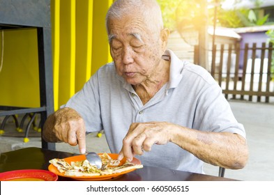 Asian Senior Man Having Roti Canai Outdoor