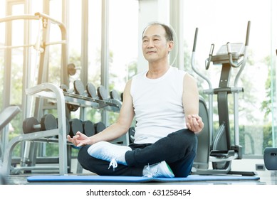 Asian Senior Man Practicing Yoga. Copy Space. Meditating