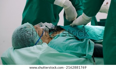 Asian senior man undergoing heart surgery in the operating room