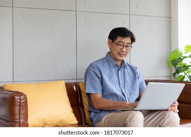 Asian Senior Man Using Computer Laptop At Home