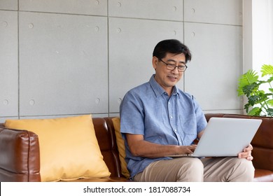 Asian Senior Man Using Computer Laptop At Home