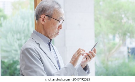 Asian senior man using smartphones