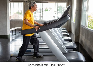 Asian Senior Man Walking Exercise On Treadmill Workout In Fitness Gym . Sport , Trainnig , Retired , Older , Mature, Elderly