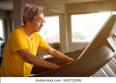 Asian Senior Man Walking Exercise On Treadmill Workout In Fitness Gym . Sport , Trainnig , Retired , Older , Mature, Elderly