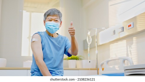 Asian Senior Man Wearing Face Mask With Thumbs Up Gesture After Gettin Vaccine Injection At Hospital