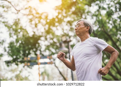 Asian Senior Mature Man Running Jogging In Park