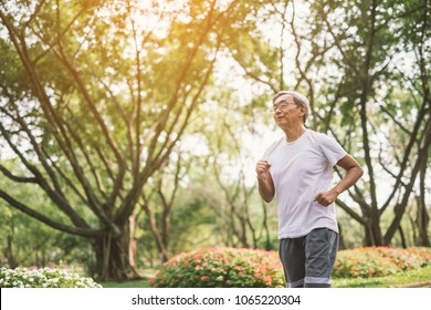 Asian Senior Mature Man Running Jogging In Park