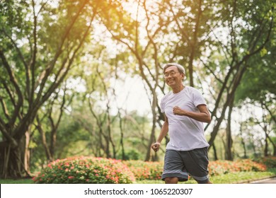 Asian Senior Mature Man Running Jogging In Park