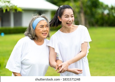 Asian Senior Mother And Adult Daughter Holding Hands And Exercise Walking Outdoor At  Park. 