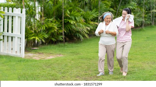 Asian Senior Mother And Adult Daughter Holding Hands And Exercise Walking Outdoor At  Park. 