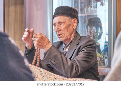 Asian Senior Muslim Man, Mullah Talking Counting Rosary At Rural House.