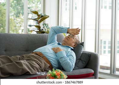 Asian Senior Old Patient Feeling Depressed Disparaged Stress From Financial Problem In Virus Pandemic Time Lying On Couch In Clinic Hospital. Healthcare And Medicine Concept. Virus Pandemic Concept.