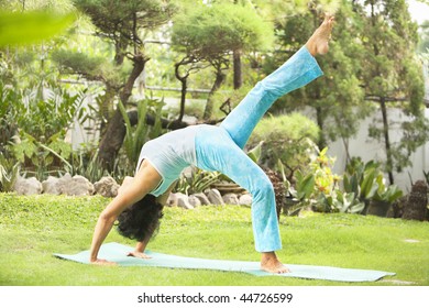 Asian senior old woman practicing yoga at garden - Powered by Shutterstock