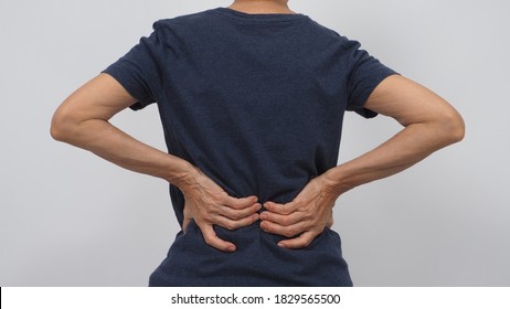 Asian Senior Or Older Woman Had A Back Pain Posture On White Background. 