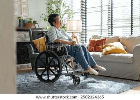 Similar – Senior woman in a wheelchair alone in a room