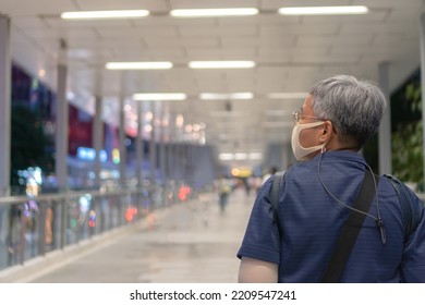 Asian Senior Tourist Traveler With Wearing Face Mask While COVID-19 Virus Disease Coronavirus Outbreak Walking Around City At Night Road, Older Woman Travelers Travel Alone On Street Enjoy On Vacation