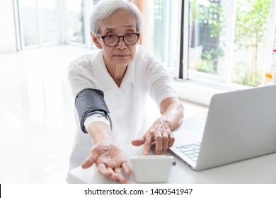 Asian Senior Woman Checking Blood Pressure At Home, Elderly People Check Health Using A Blood Pressure Monitor, Checking Patients Blood Pressure Measurement By Yourself,health Care Concept