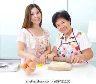 Asian Senior Woman And Daughter Prepare For Baking In The Kitchen