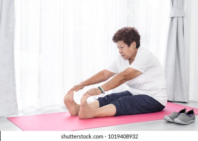 Asian senior woman doing exercise at home.