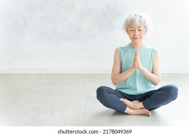 Asian senior woman doing yoga - Powered by Shutterstock