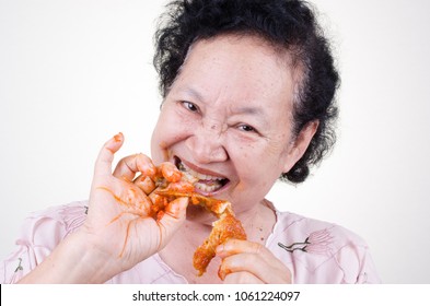 Asian Senior woman eat fried chicken over white background