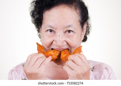 Asian Senior woman eat fried chicken