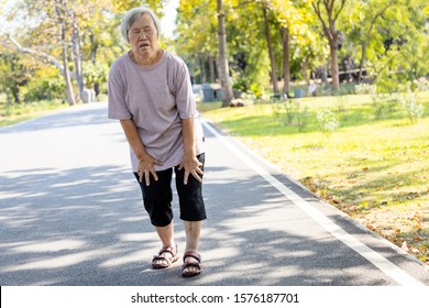 Asian senior woman is extremely tired while walking at park, body is weak feeling tired easily due to lack of energy and don’t exercise very often, exhausted elderly people have the symptoms fatigue
