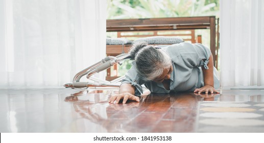 Asian Senior Woman Falling Down On Lying Floor At Home After Stumbled At The Doorstep And Crying In Pain And Asking Someone For Help. Concept Of Old Elderly Insurance And Health Care