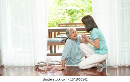 Asian senior woman falling down on lying floor at home after Stumbled at the doorstep and Crying in pain and the nurse came to help support. Concept of old elderly insurance and health care