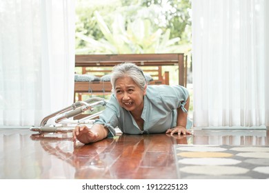 Asian Senior Woman Falling Down On Lying Floor At Home After Stumbled At The Doorstep And Crying In Pain And Asking Someone For Help. Concept Of Old Elderly Insurance And Health Care