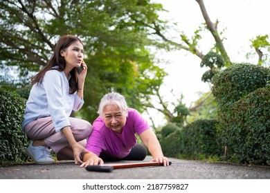 Asian Senior Woman Fell Down On Lying Floor Because Faint And Limb Weakness And Pain From Accident And Woman Came To Help Support And Call Emergency. Concept Of Old Elderly Insurance And Health Care